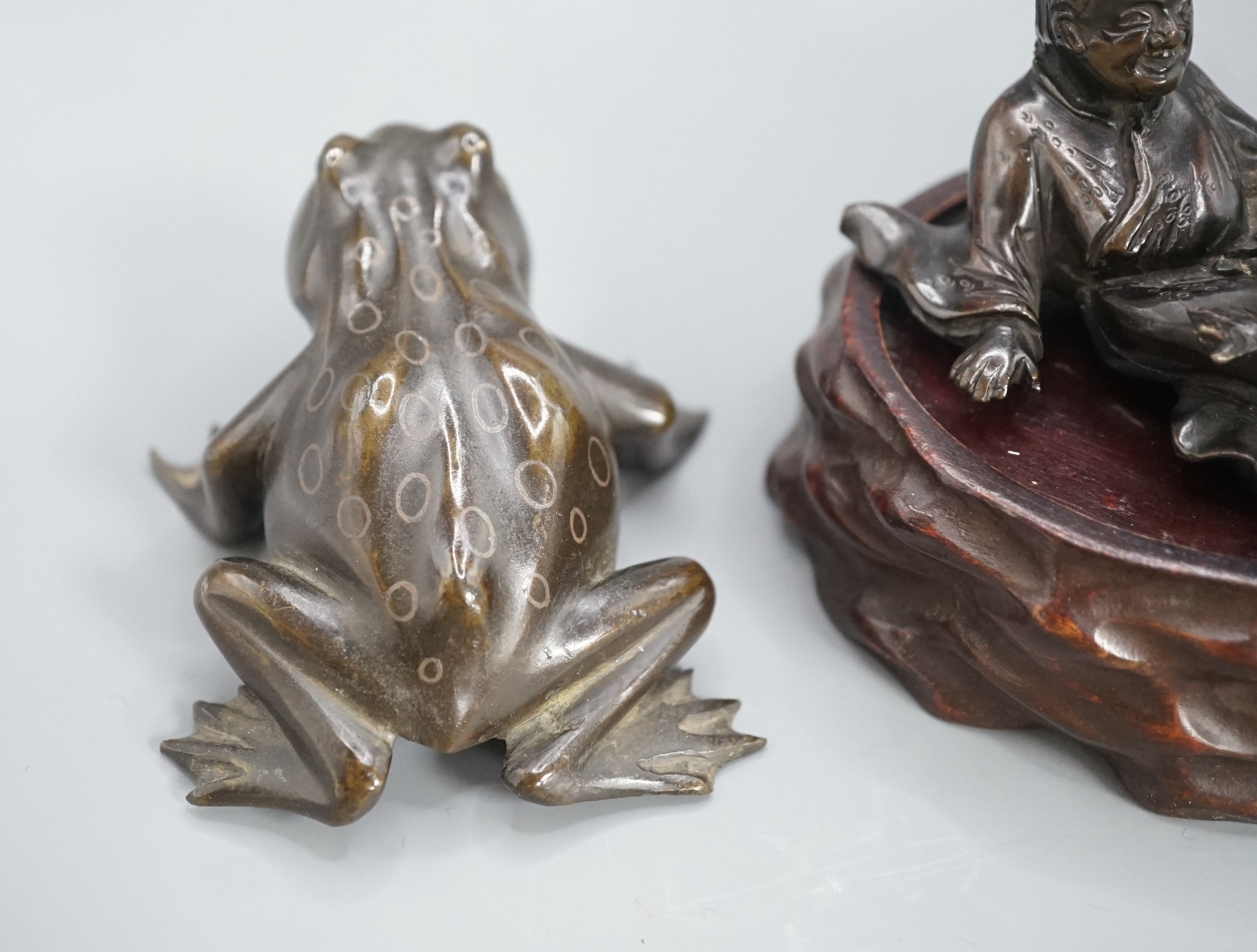 A Chinese bronze group of Liu Hai and a toad, wood stand and a bronze figure of a dog, 9cm